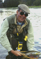 Dr Langbourne Rust - holding a fly-caught brown trout